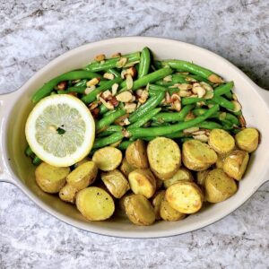 Green beans almandine and roasted potatoes in casserole dish