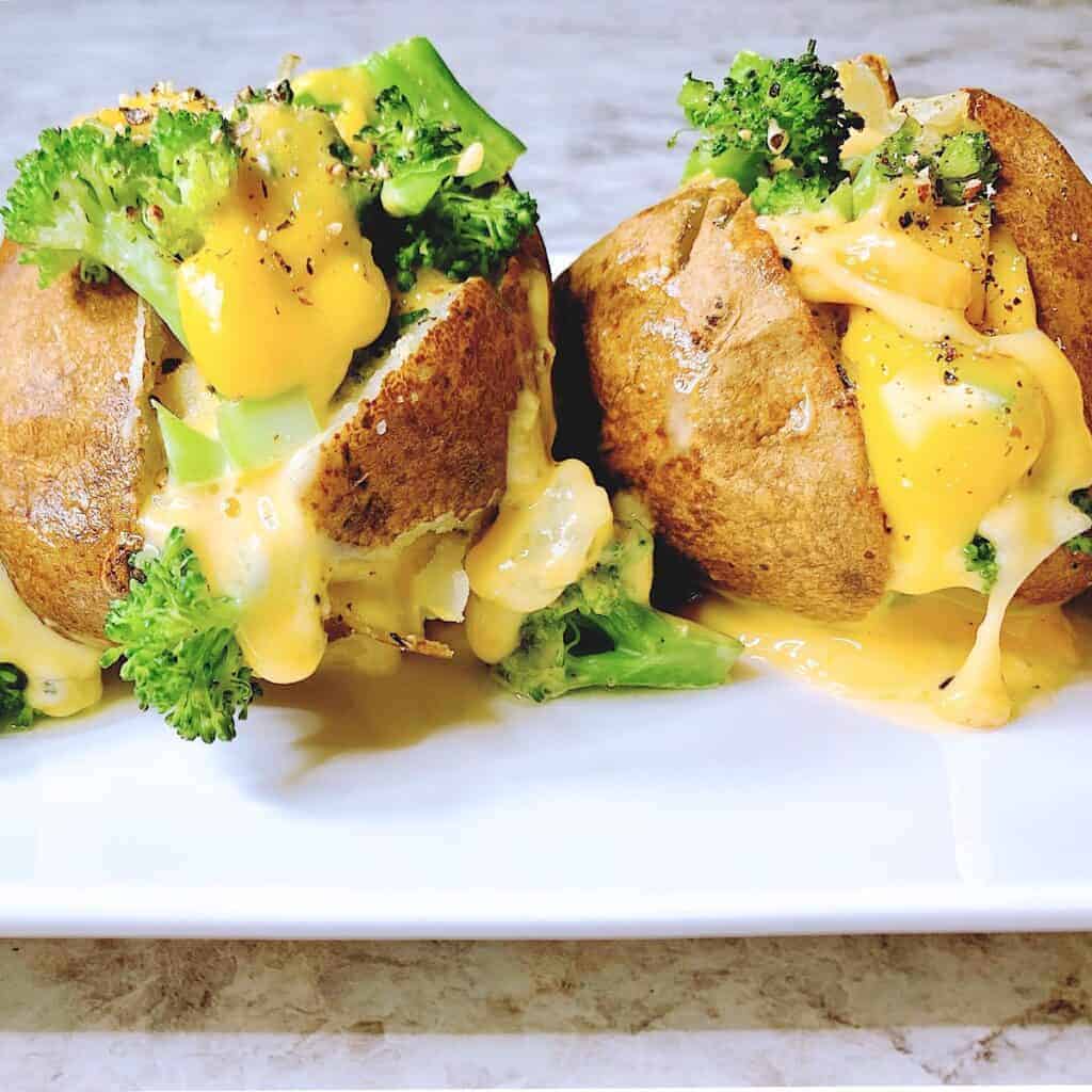 Close up of baked potatoes stuffed with broccoli and melted cheese