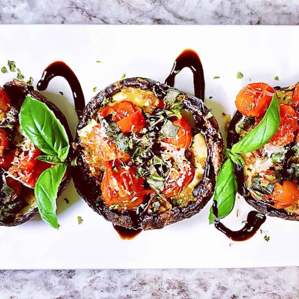 Stuffed Caprese portobellos close up with balsamic glaze