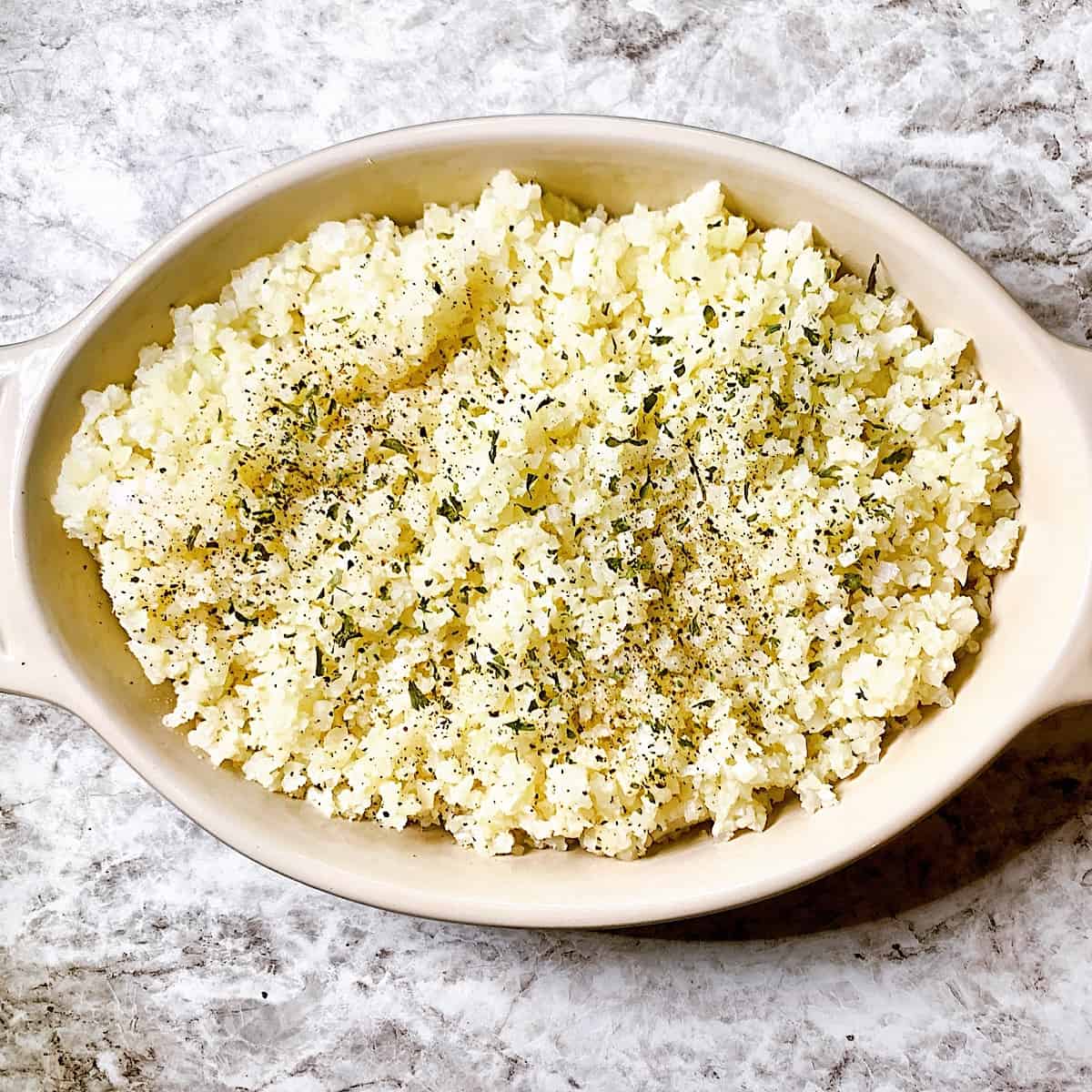Casserole dish filled with garlic cauliflower rice