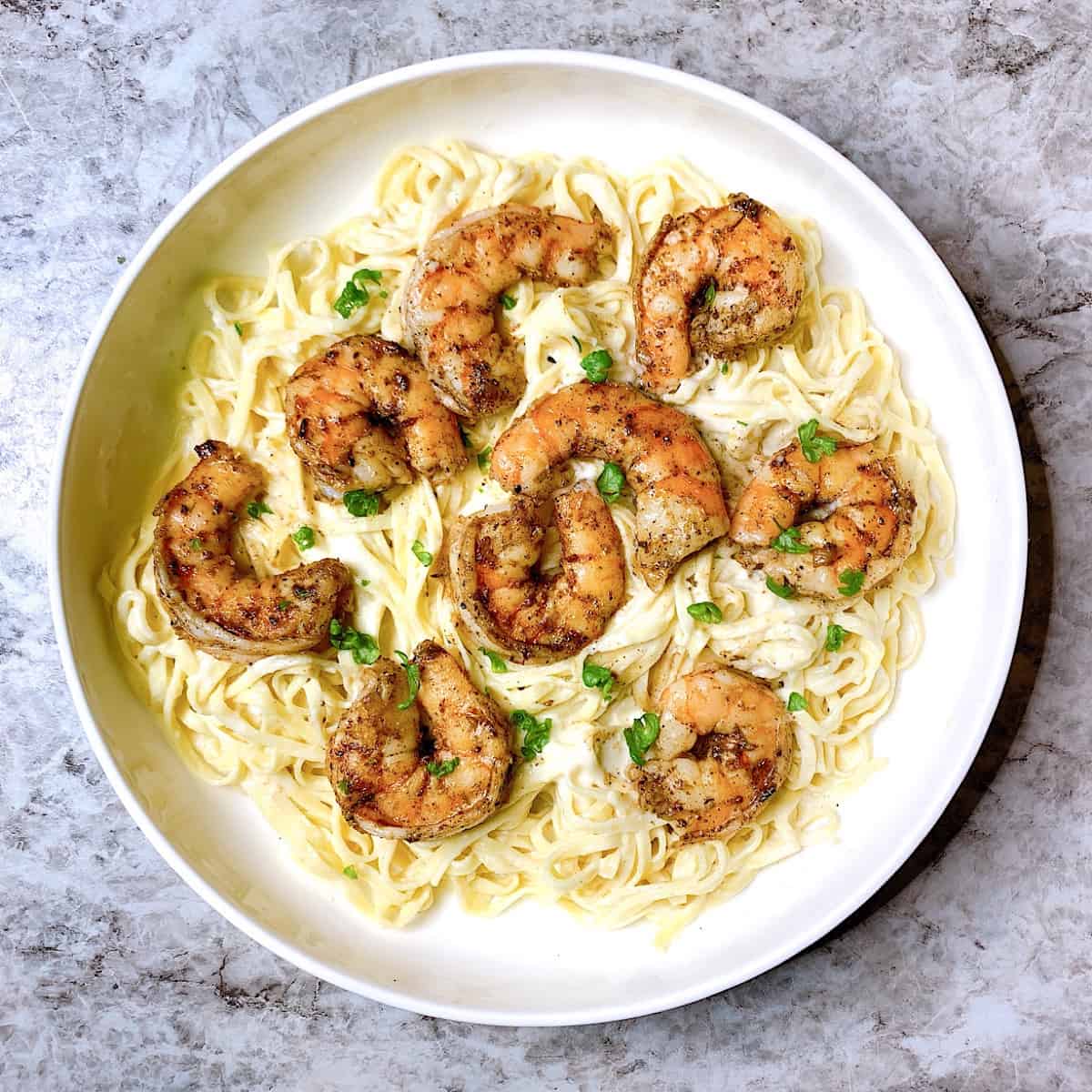Linguini Alfredo with Blackened Shrimpβ in large pasta bowl