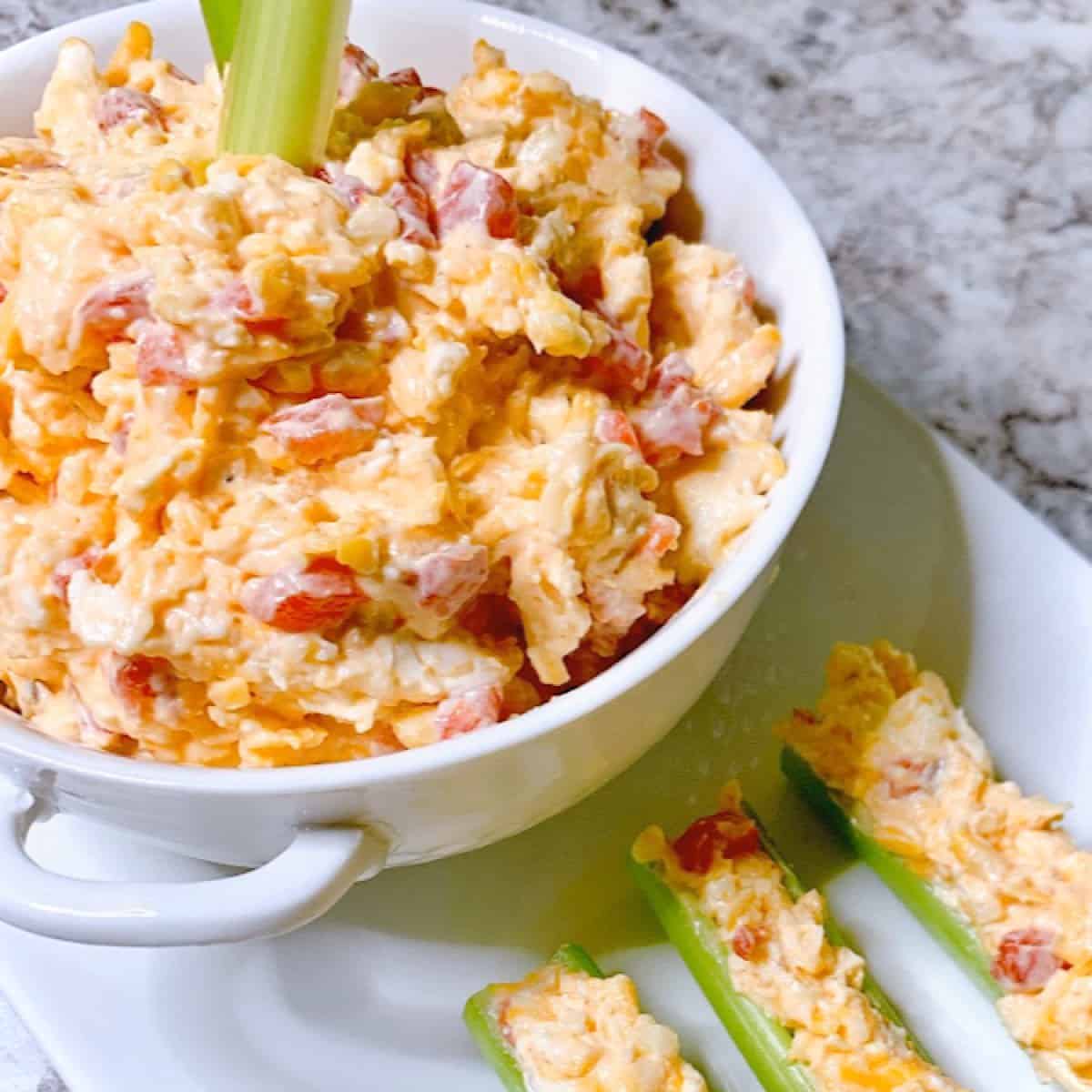 Pimento Spread in small white bowl with celery