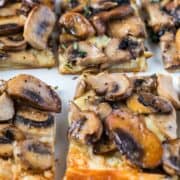 Square slices of mushroom gruyere tart with thyme.