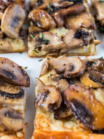Square slices of mushroom gruyere tart with thyme.