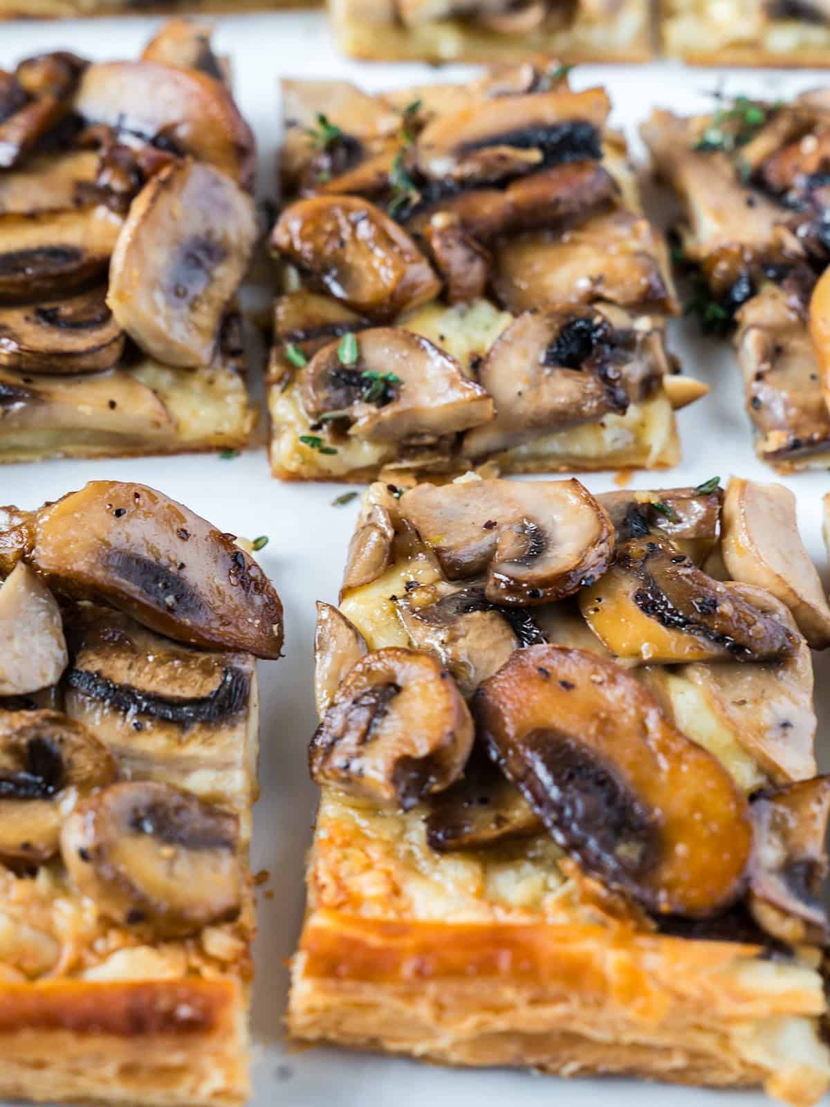 Square slices of mushroom gruyere tart with thyme.