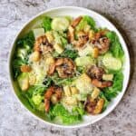 Blackened shrimp caesar in a white bowl.