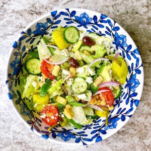 tossed greek salad in decorative blue bowl