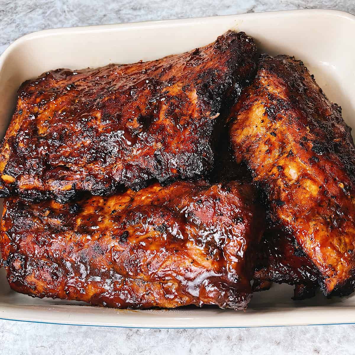 Smoked Barbecue Ribs in piled high in Casserole Dish