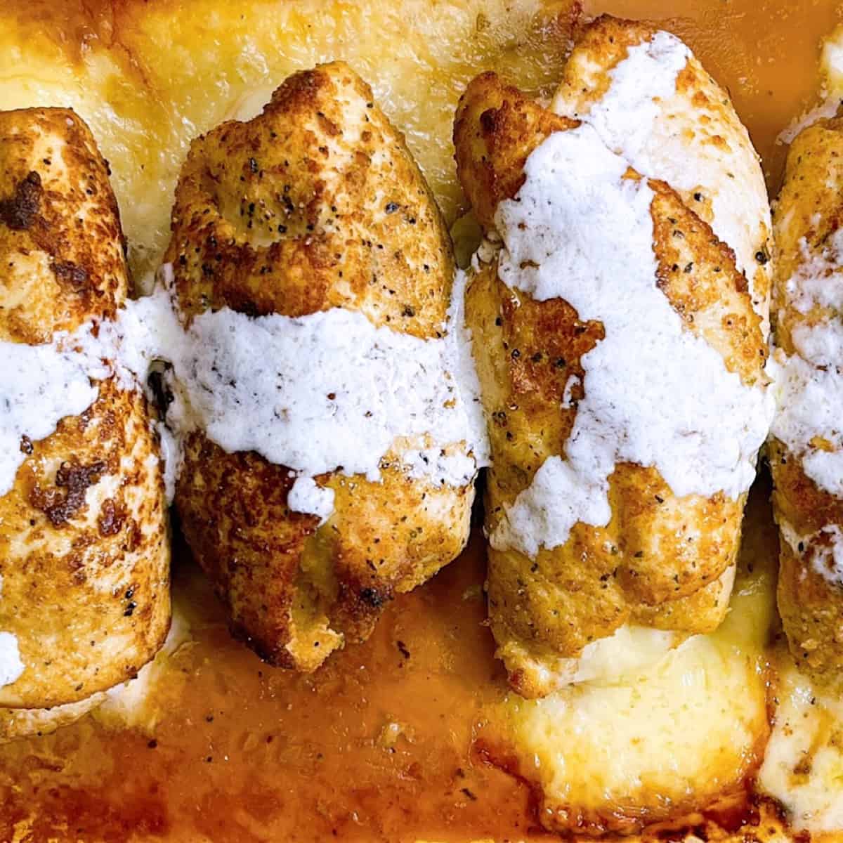 Chicken Cordon Bleu in casserole dish topped with sauce