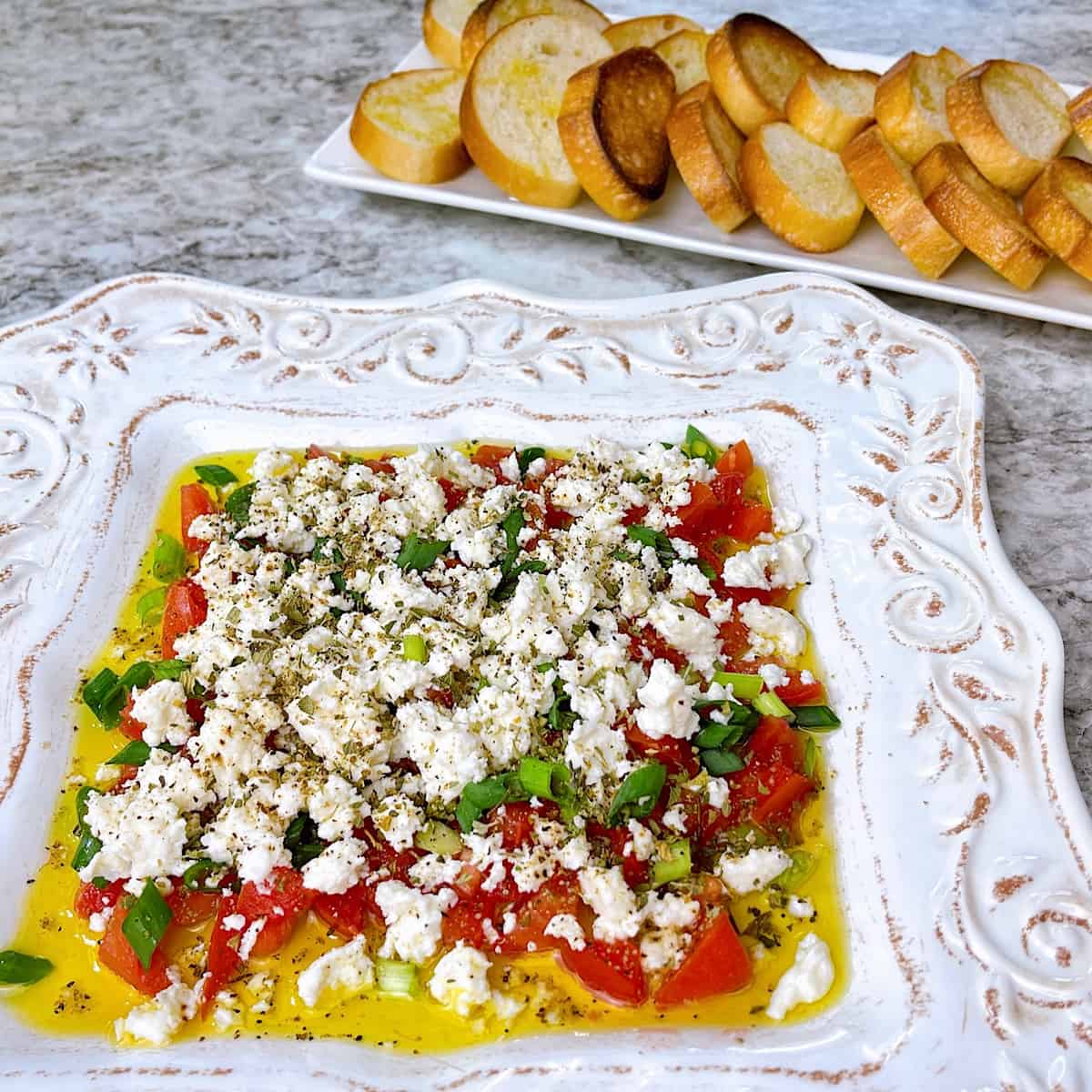 Feta dip on plate with olive oil and oregano