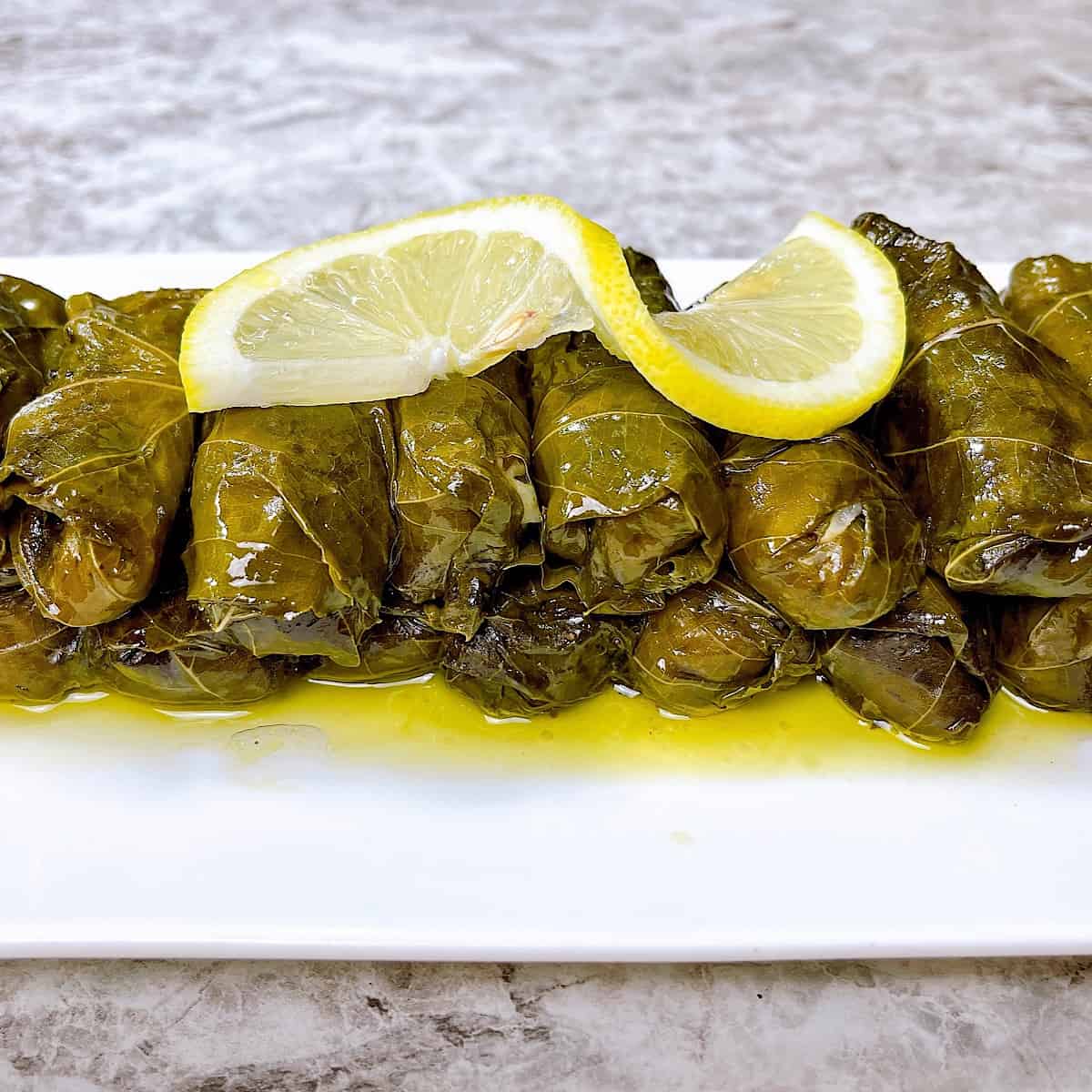 Dolmades on serving platter topped with lemon