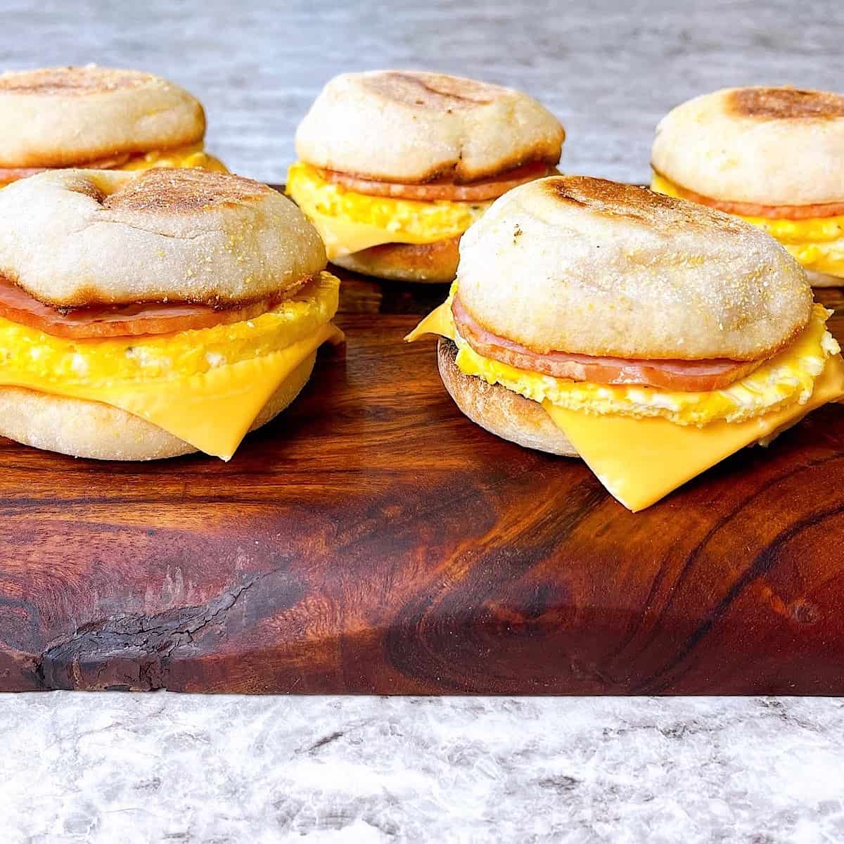 Freezer Meal Prep Breakfast Sandwiches qty 5 on a cutting board