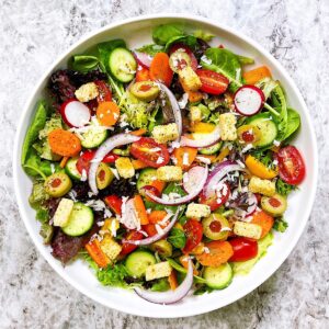 loaded veggie salad in white bowl
