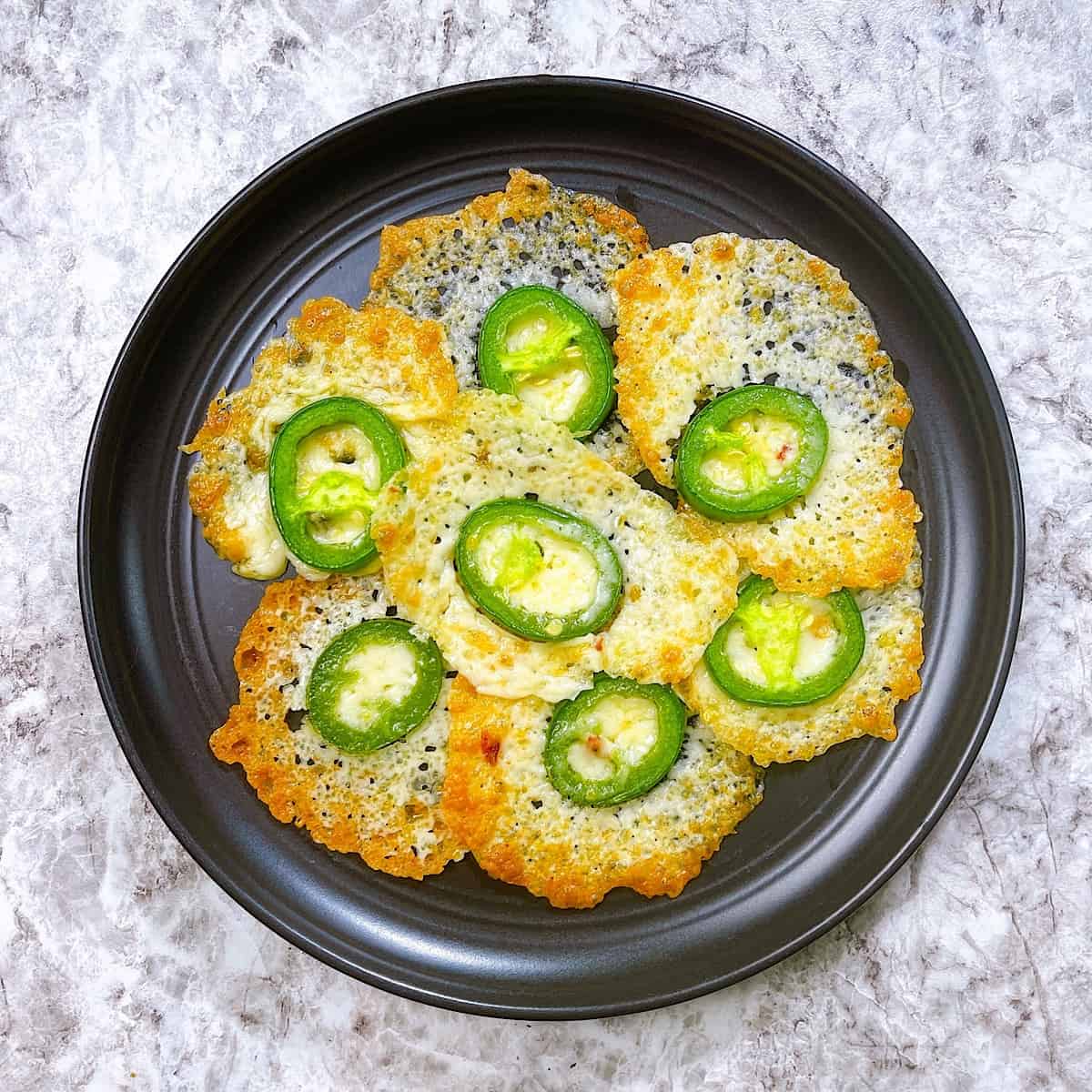Low Carb Pepper Jack Crispsβ on a black plate