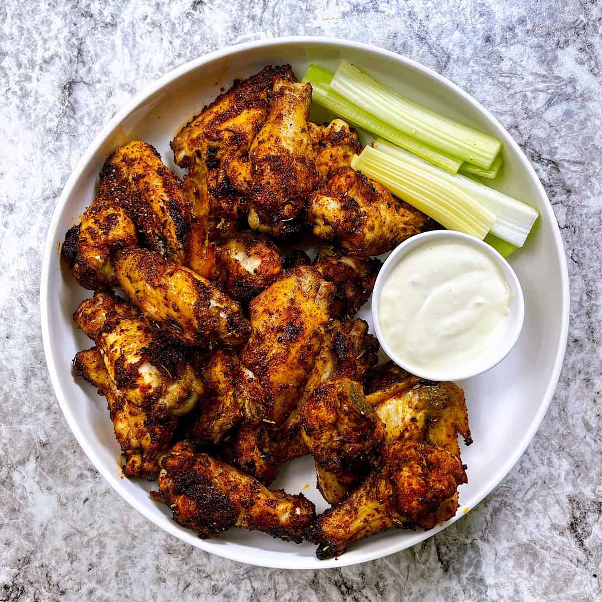 Crispy Air Fryer Wings with Dry Rub on serving platter with blue cheese and celery