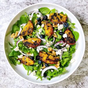 grilled peach salad in white bowl