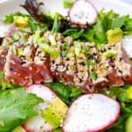 ahi tuna on a bed of greens close up
