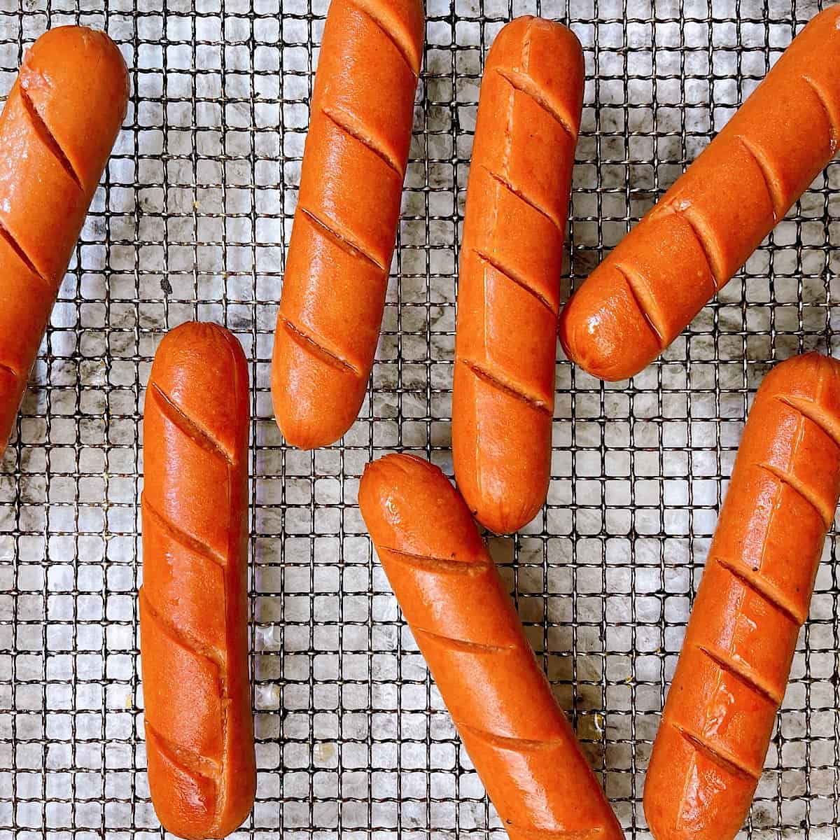 Air Fryer Hot Dogs split open on wire rack