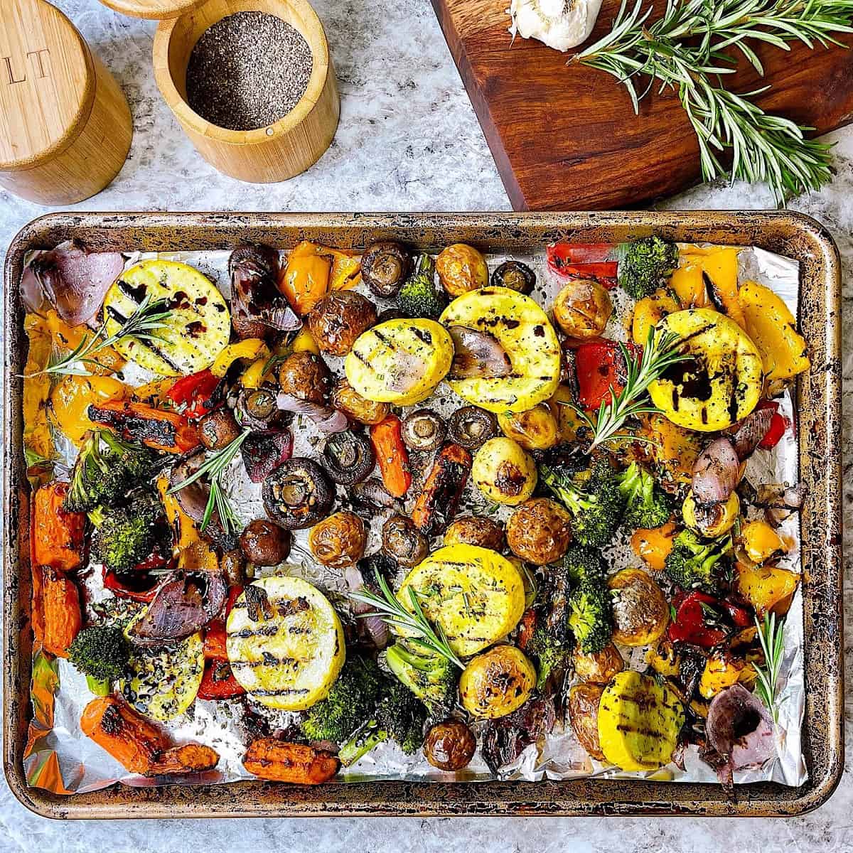 Roasted Rosemary Vegetables with Teriyaki Glaze on sheet pan with foil and topped with rosemary glaze
