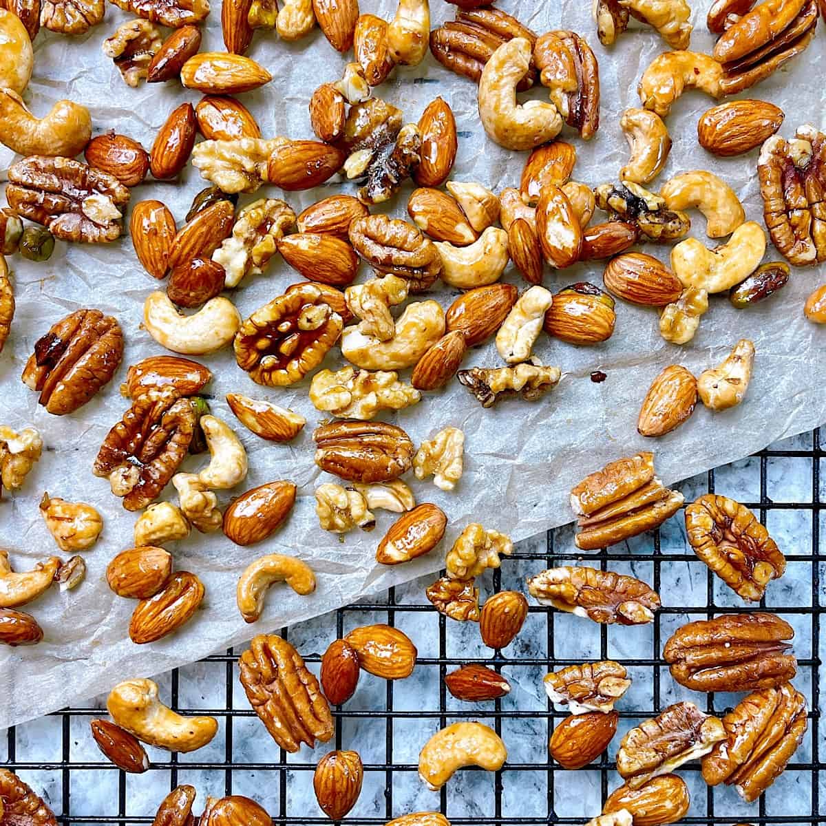 Sweet and Spicy Candied Nuts​ on wire rack with parchment 
