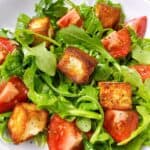 Halloumi cheese salad in a bowl with bright fresh colors.