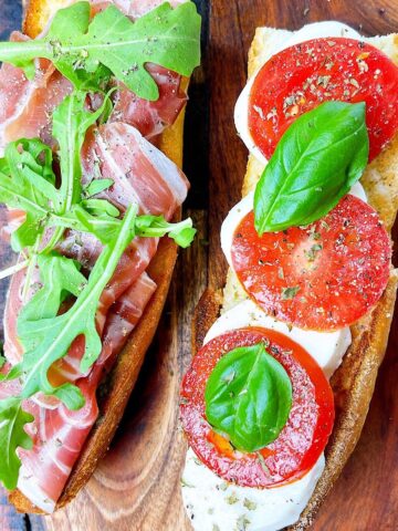 prosciutto caprese sandwich open faced with all of the fixings.