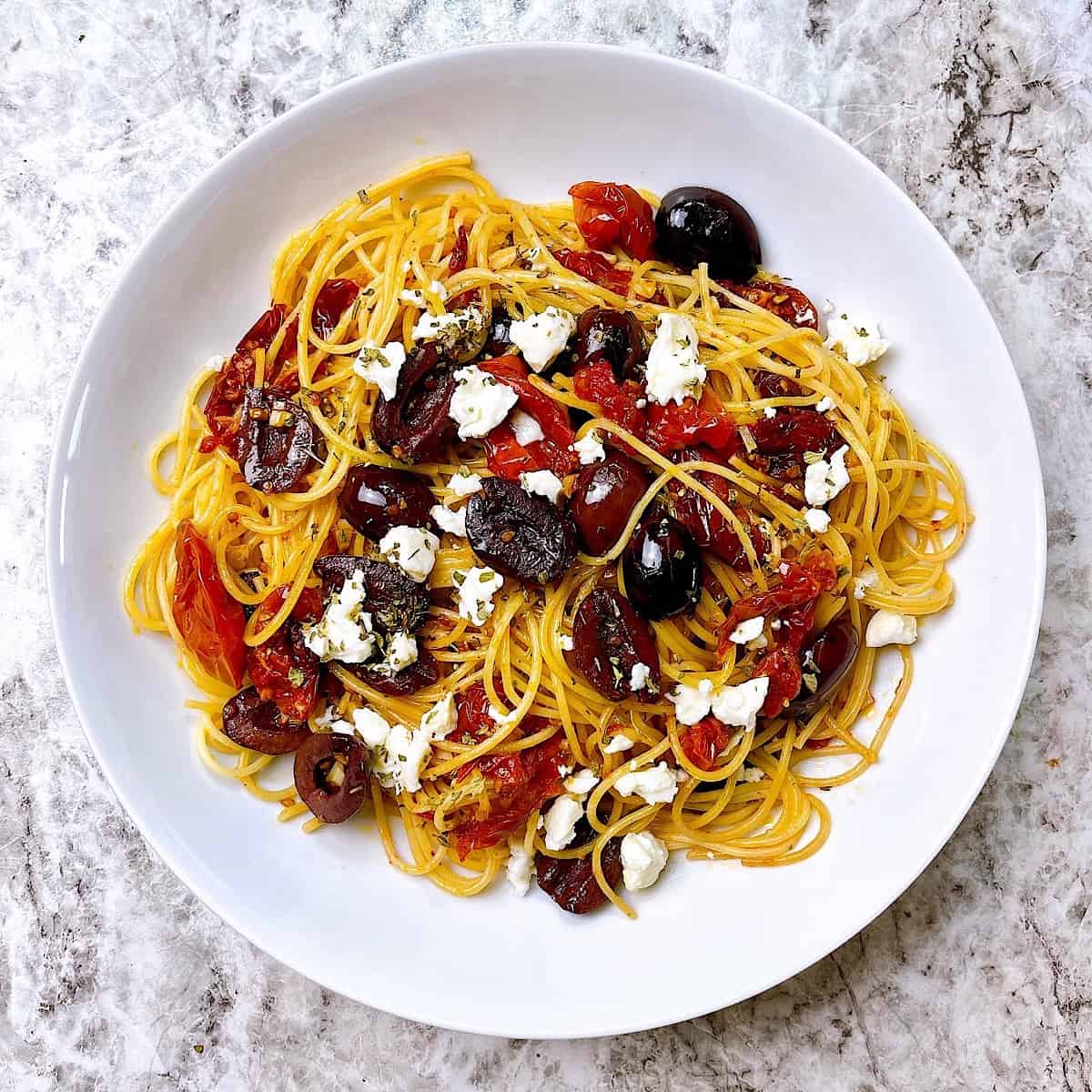 Roasted Tomato, Olive, and Feta Pasta in white bowl