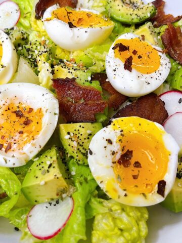 close up of salad with bacon and eggs