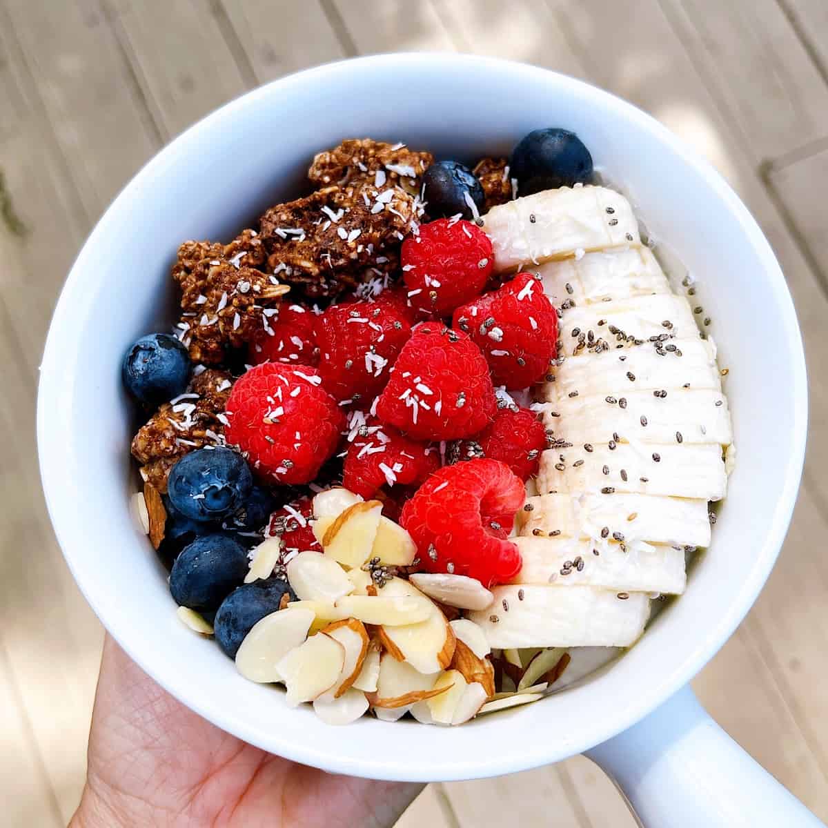 Yogurt Bowl with bananas raspberries blueberries almonds and granola