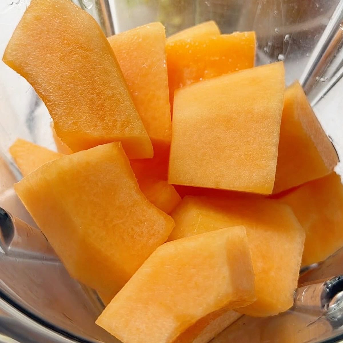 Bite sized pieces of cantaloupe melon in the blender.