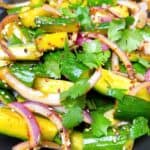 Spicy Cucumber Salad ready to eat with garnish.