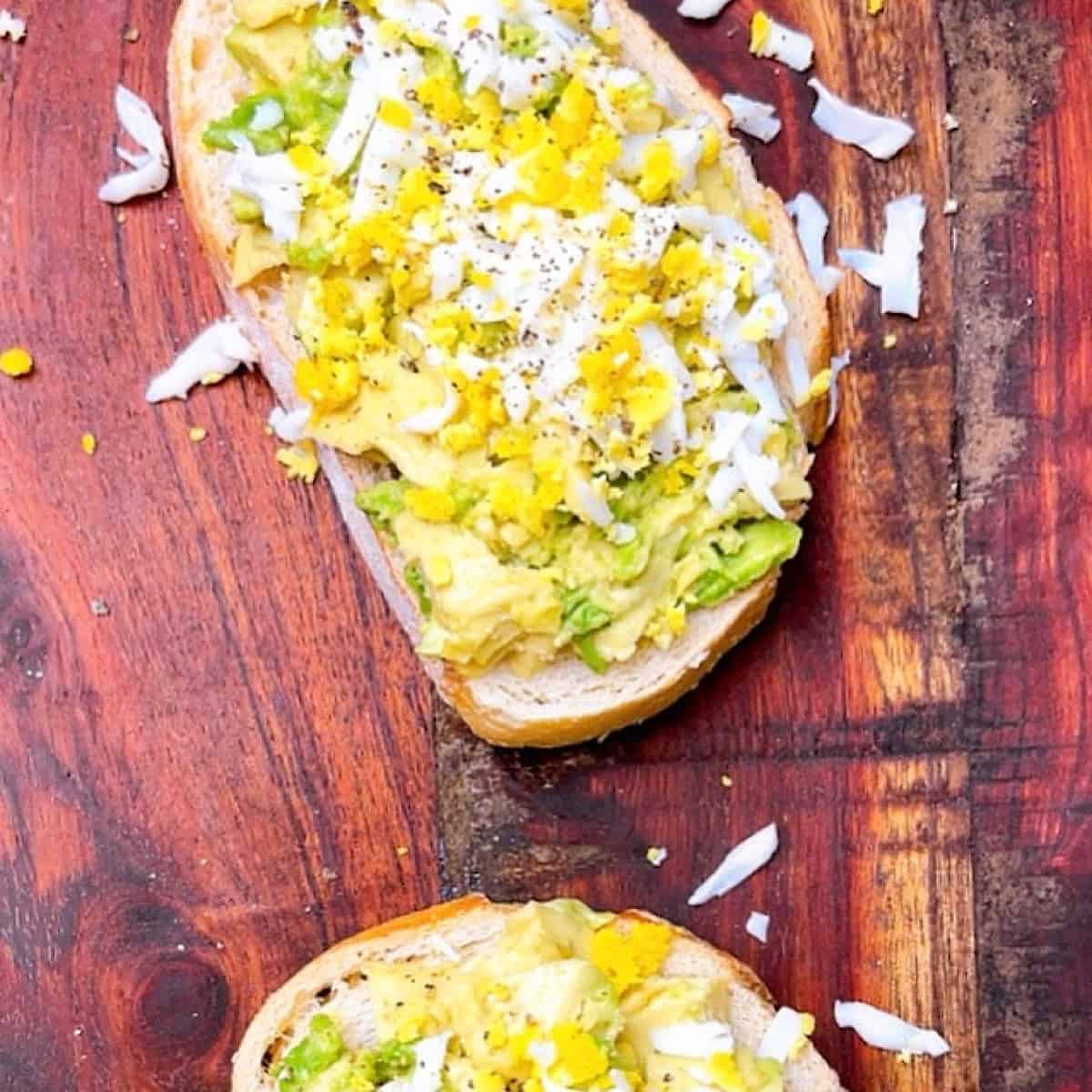 Avocado Grated Egg Toast on wooden cutting board