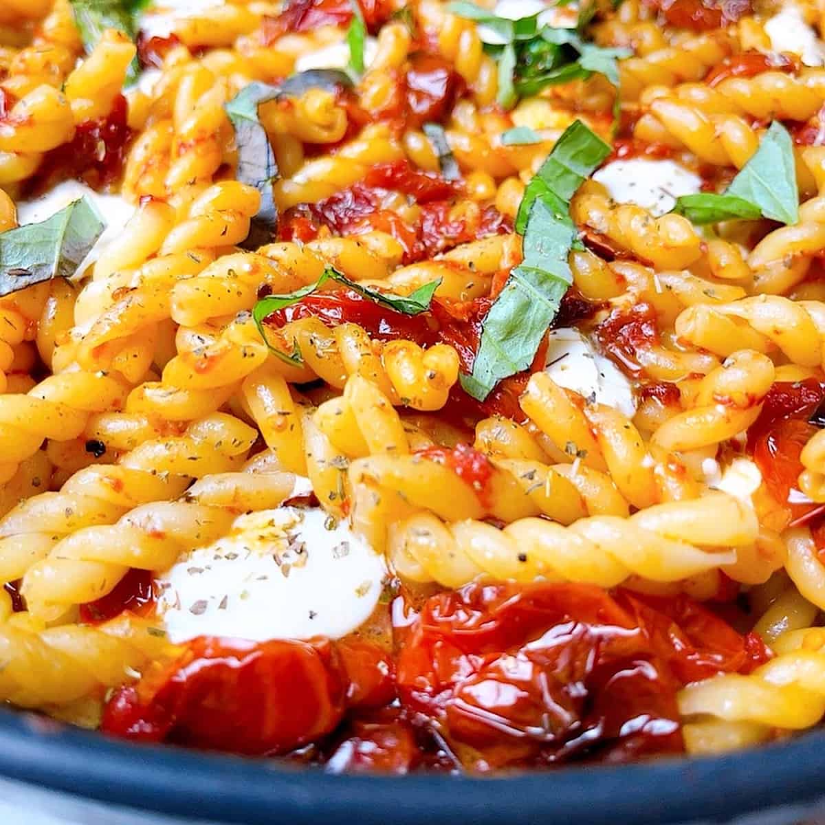 Pasta alla Sorrento close up with mozzarella and fresh basil