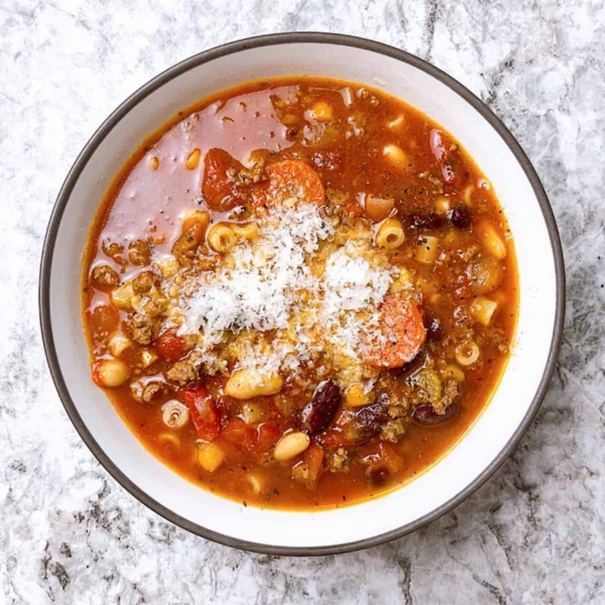 Pasta e Fagioli Soup in a bowl with Parmesan on top