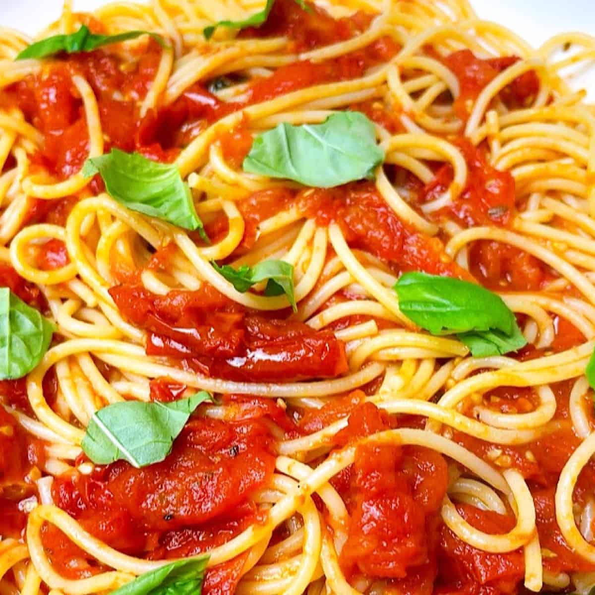 Pasta Pomodoro with chopped fresh basil close up