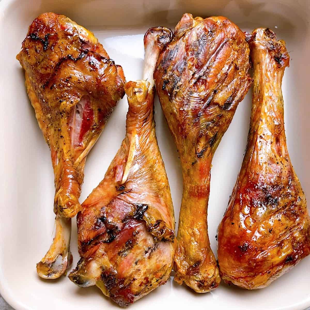 Smoked Turkey Drumsticks on platter with grill marks