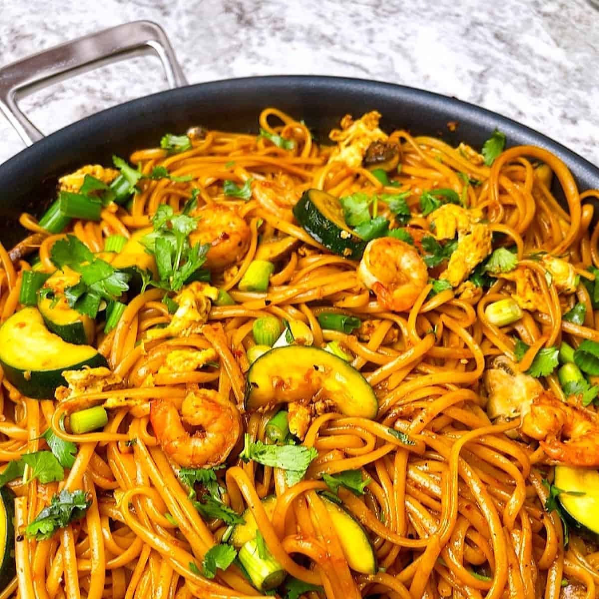 Spicy Thai Noodles in pan with garnish