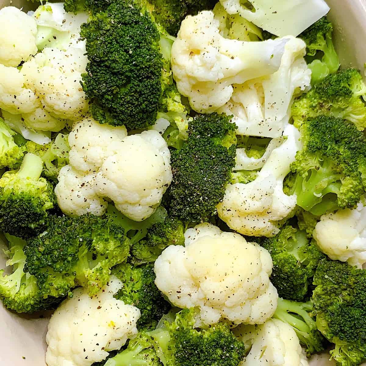 Casserole dish with steamed broccoli and cauliflower
