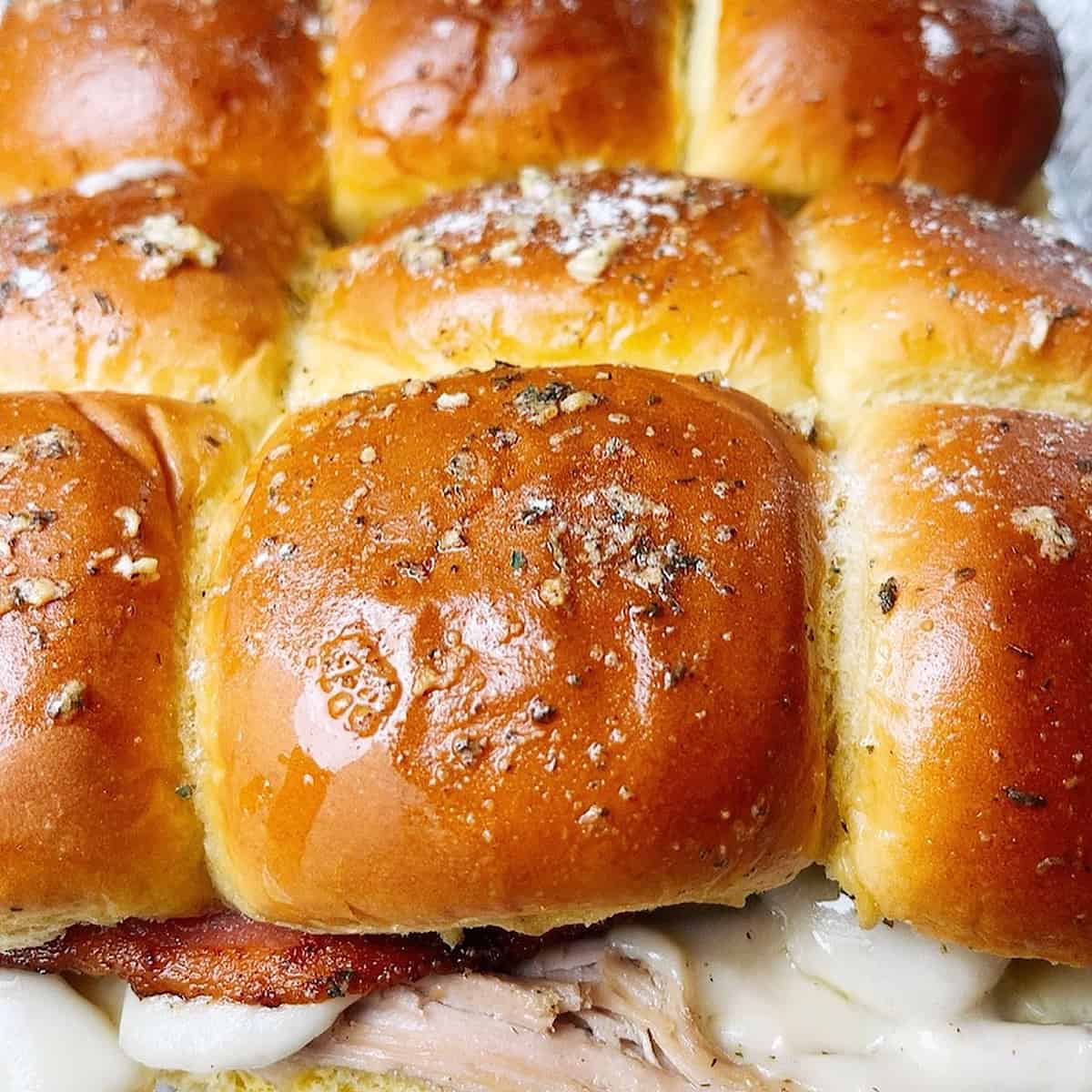 Turkey Bacon Ranch Sliders topped with butter and seasoning