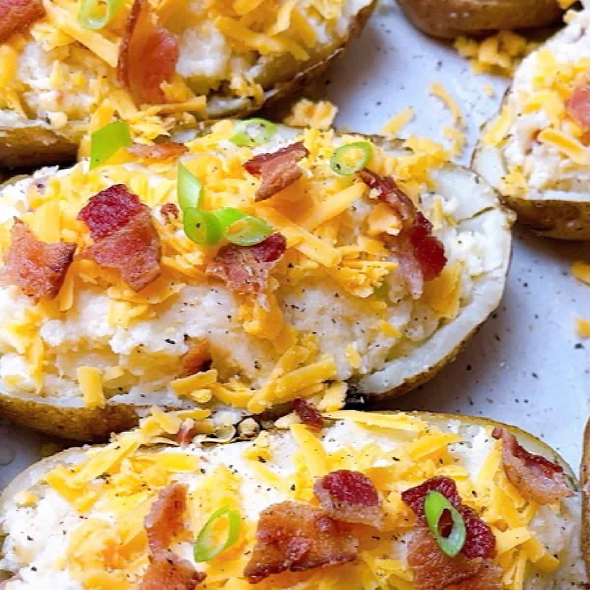 Twice Baked Potatoes on sheet pan close up with toppings