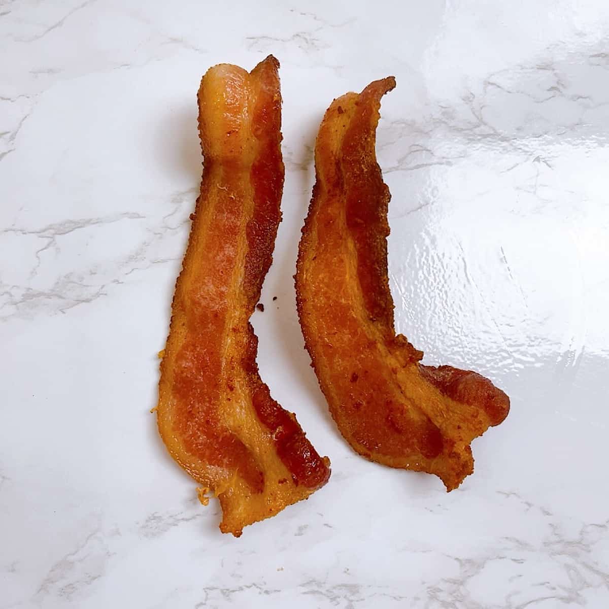 Two pieces of fried bacon