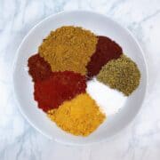 Chipotle spices measured in a white bowl.