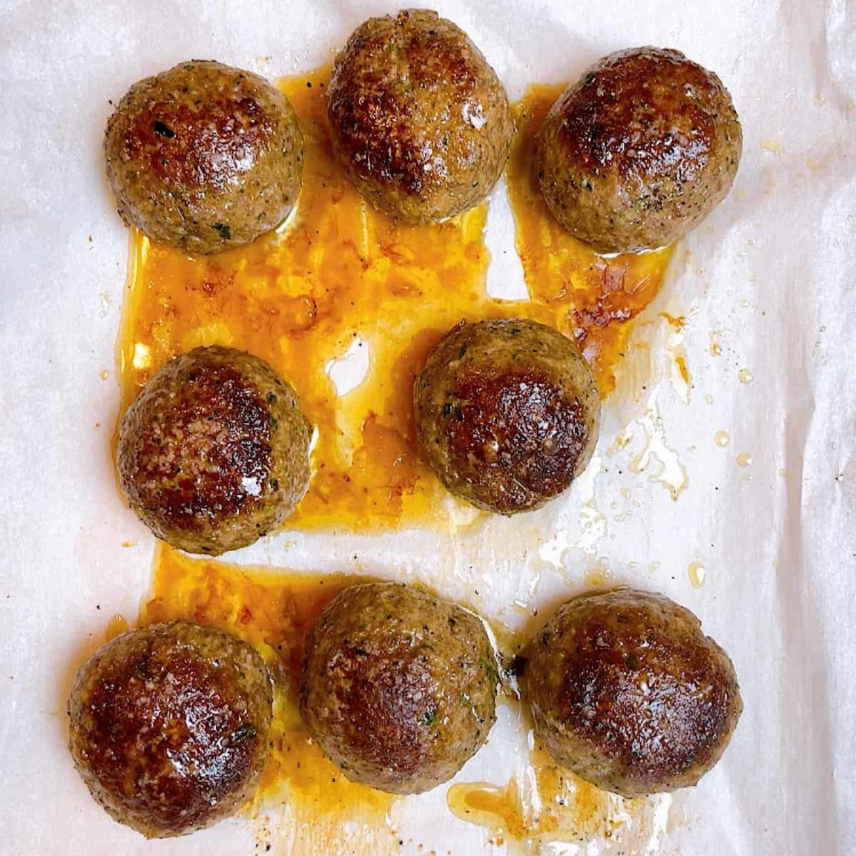 Cooked meatballs on a sheet pan