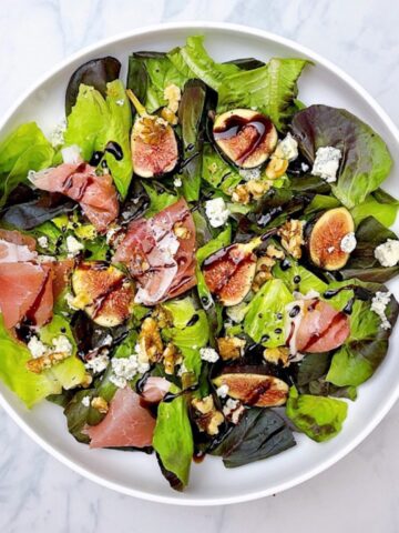 Fig and Prosciutto Salad with Goat Cheese and Balsamic in white bowl
