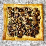 Whole mushroom puff pastry tart with gruyere cheese and thyme.