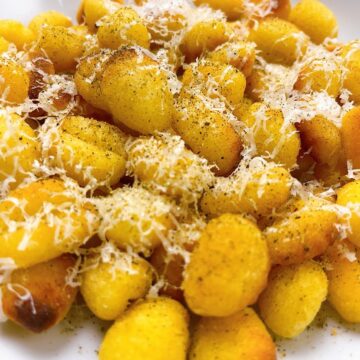 Close up of toasted air fryer gnocchi with brown butter and parmesan feature