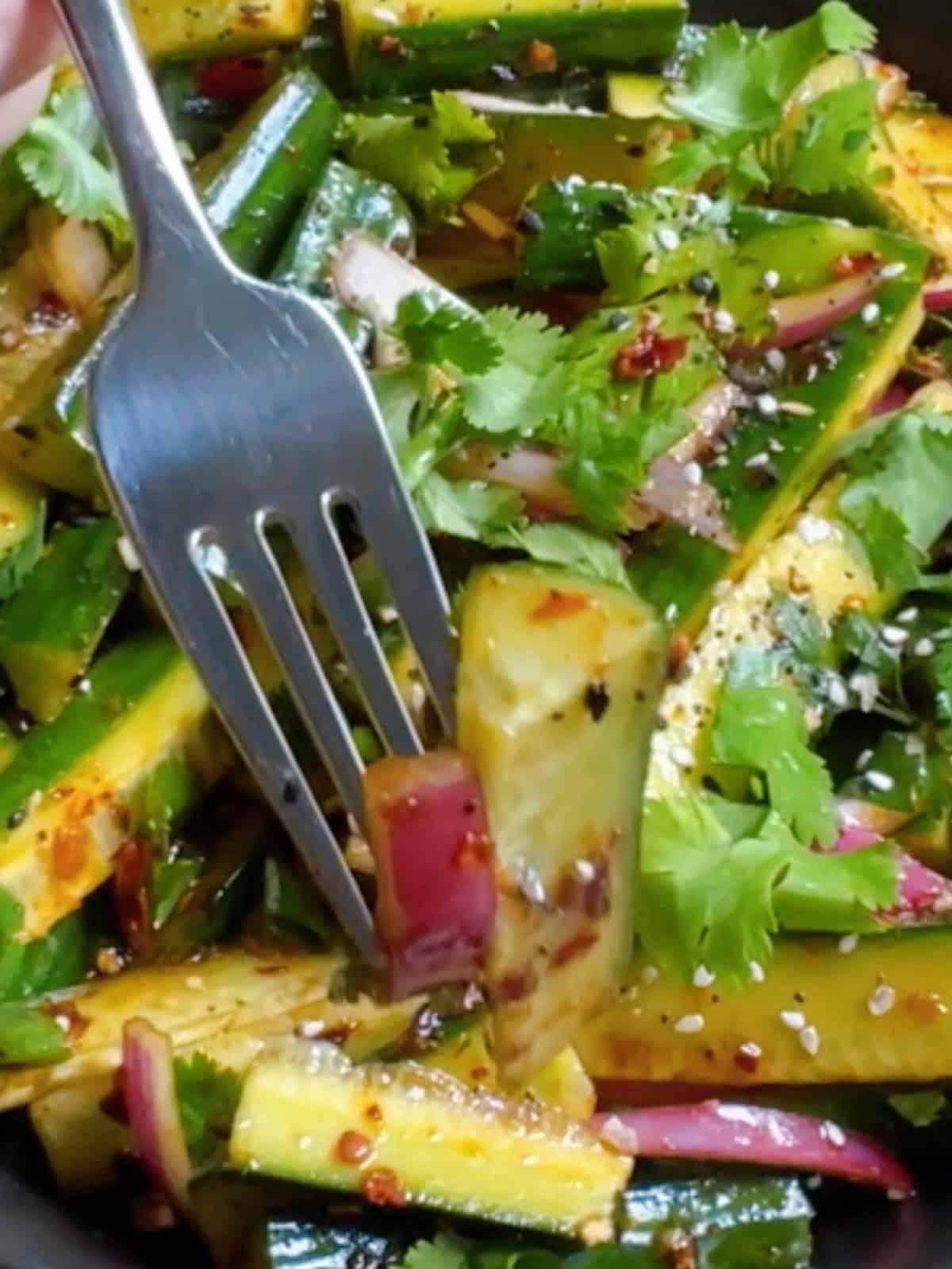 Spicy cucumber salad close up with fork hero image