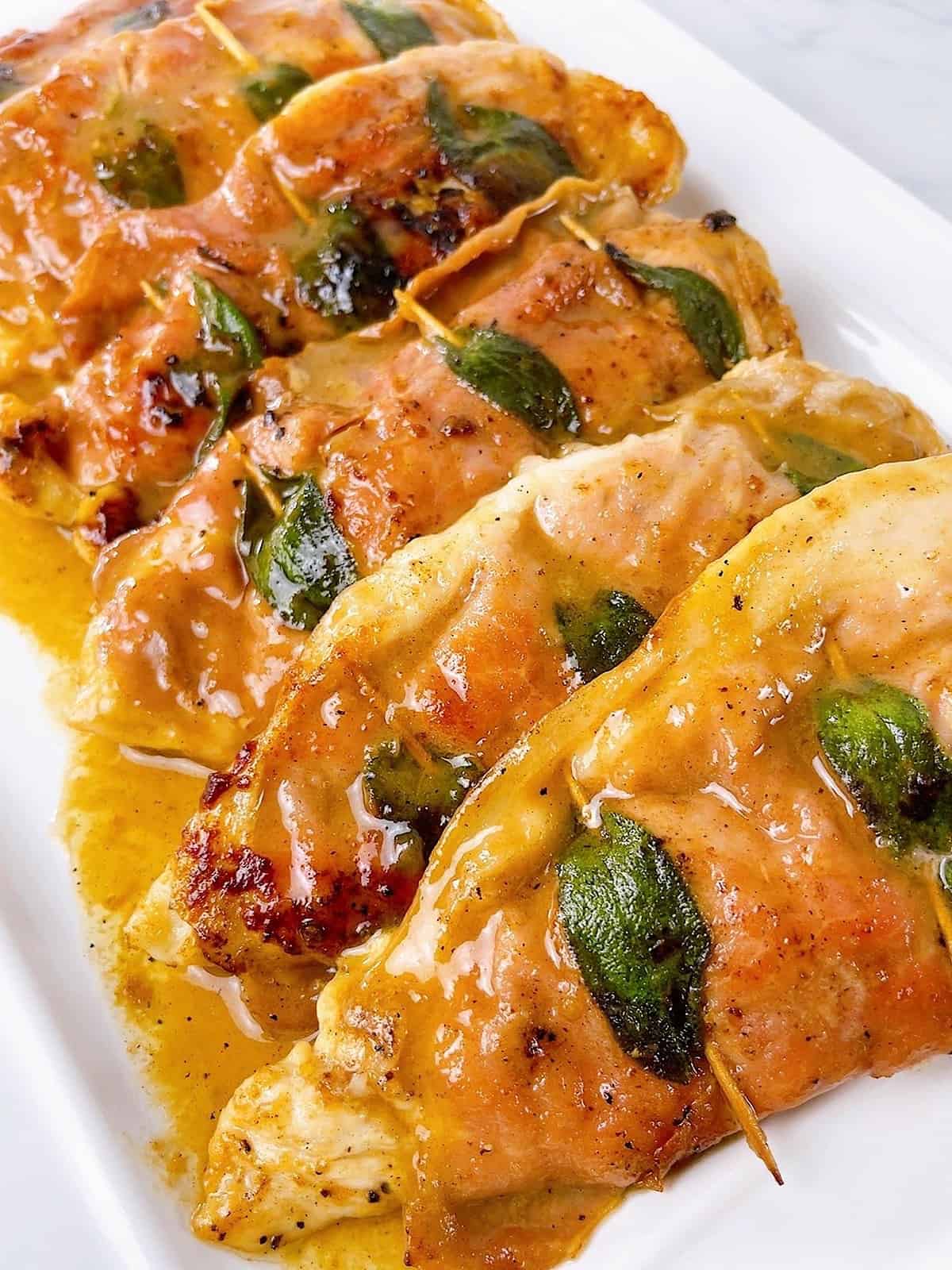Chicken Saltimbocca on a platter with sauce