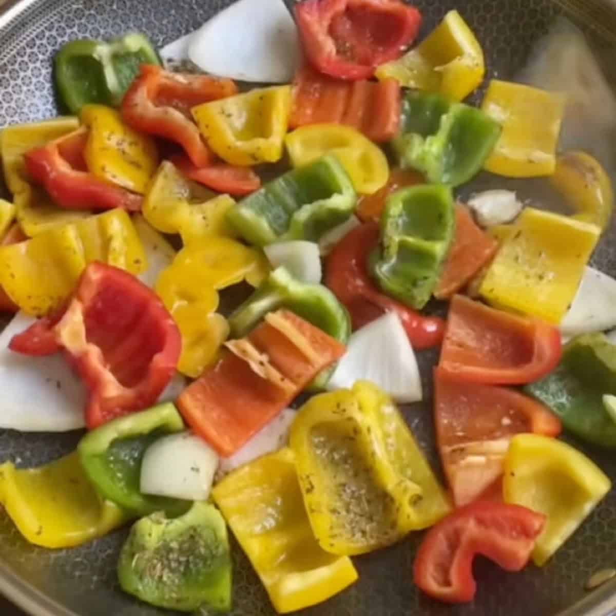 Charring the bell pepper and onion in the skillet.