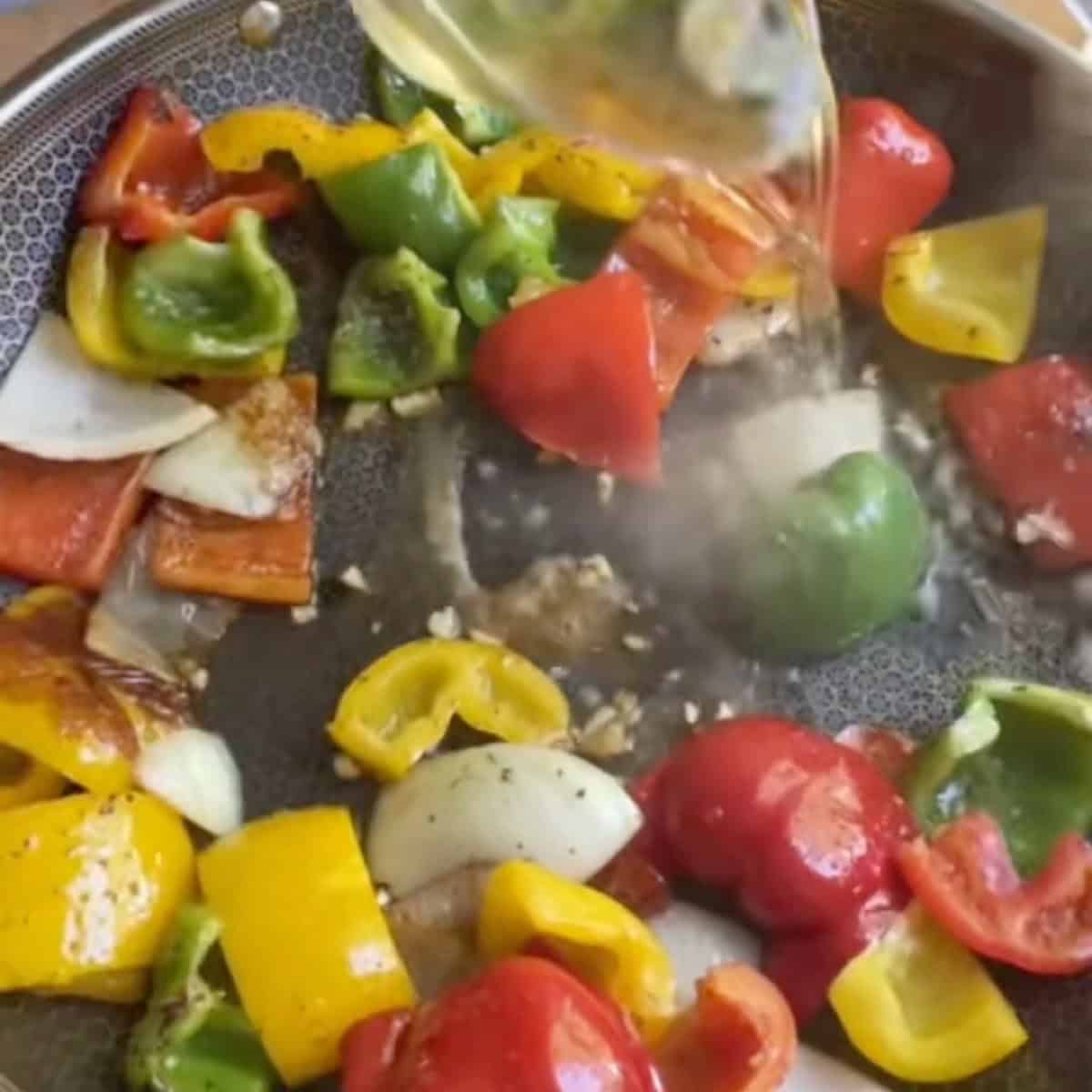 Deglazing with white wine and adding garlic.